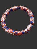 Handcrafted red white and blue painted Krobo glass beads from Ghana featuring blue dot accents and traditional artisan patterns on recycled glass tube beads.
