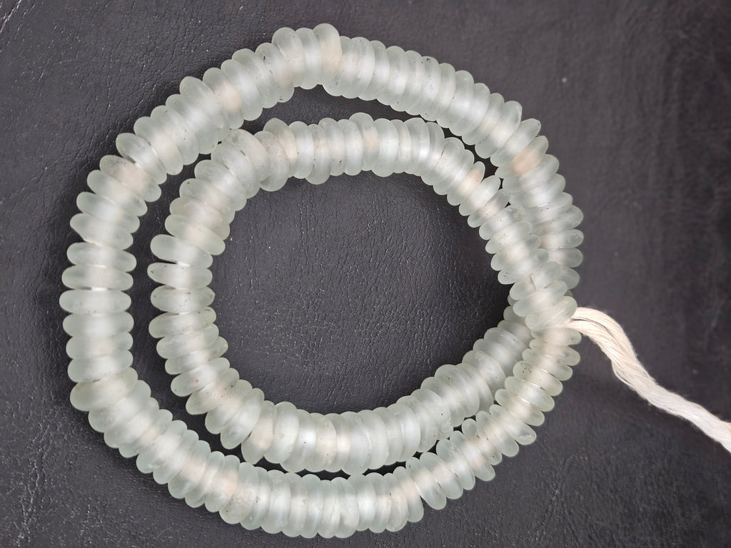 Authentic handmade frost white Krobo translucent recycled glass rondelle beads from Ghana featuring a matte frosted finish for jewelry making, designer collections, and wholesale sourcing.