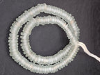 Authentic handmade frost white Krobo translucent recycled glass rondelle beads from Ghana featuring a matte frosted finish for jewelry making, designer collections, and wholesale sourcing.