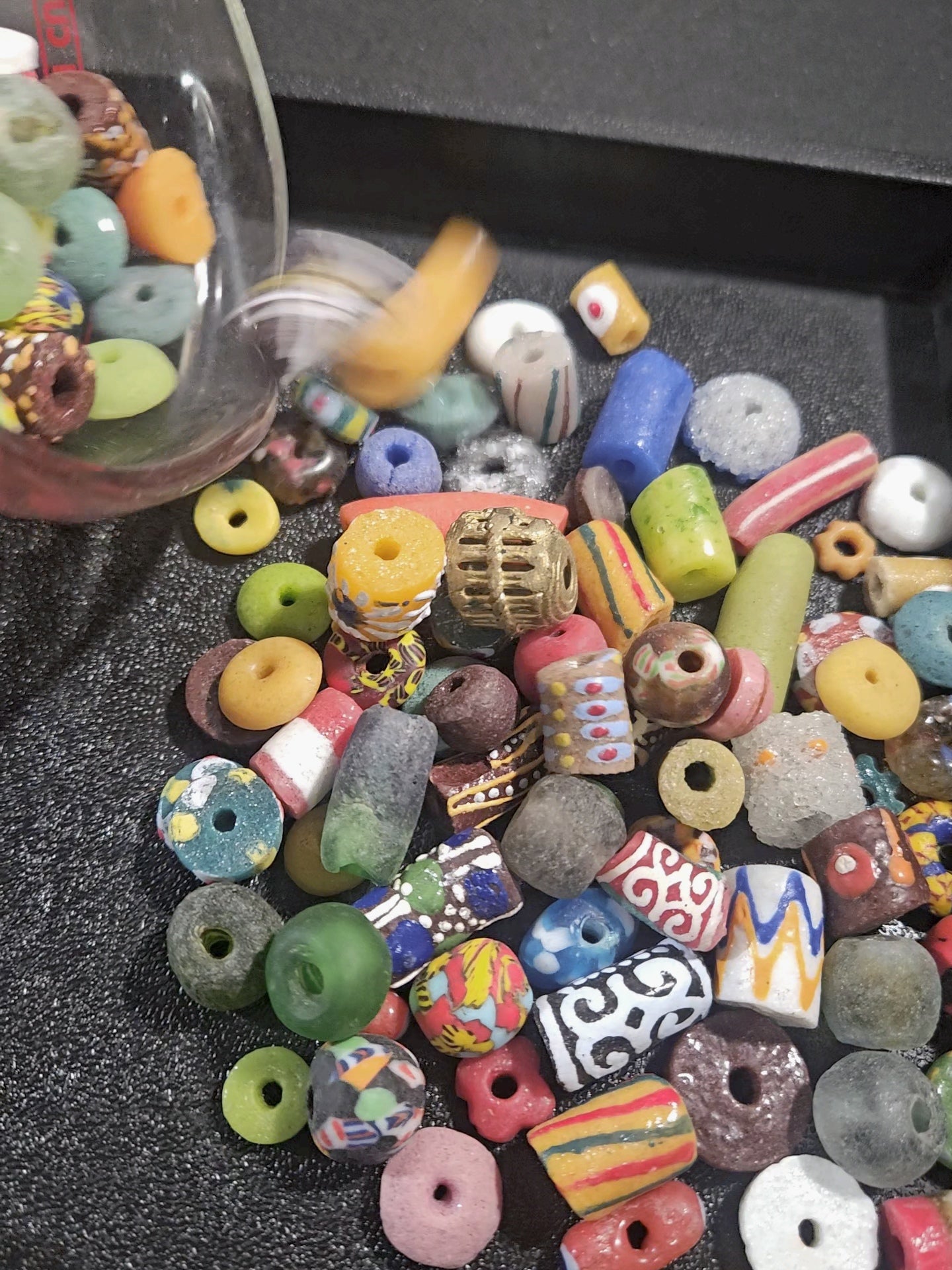 Beads being poured onto a surface, showcasing bright festival tones.