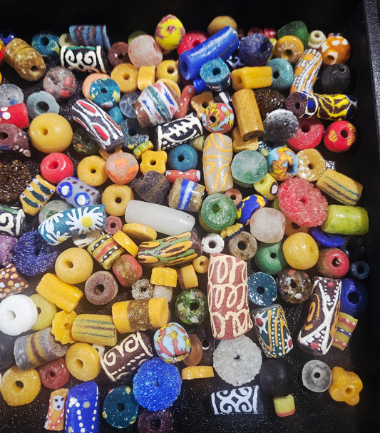 Close-up of jewel-colored Krobo artisan beads with matte and glossy finish.