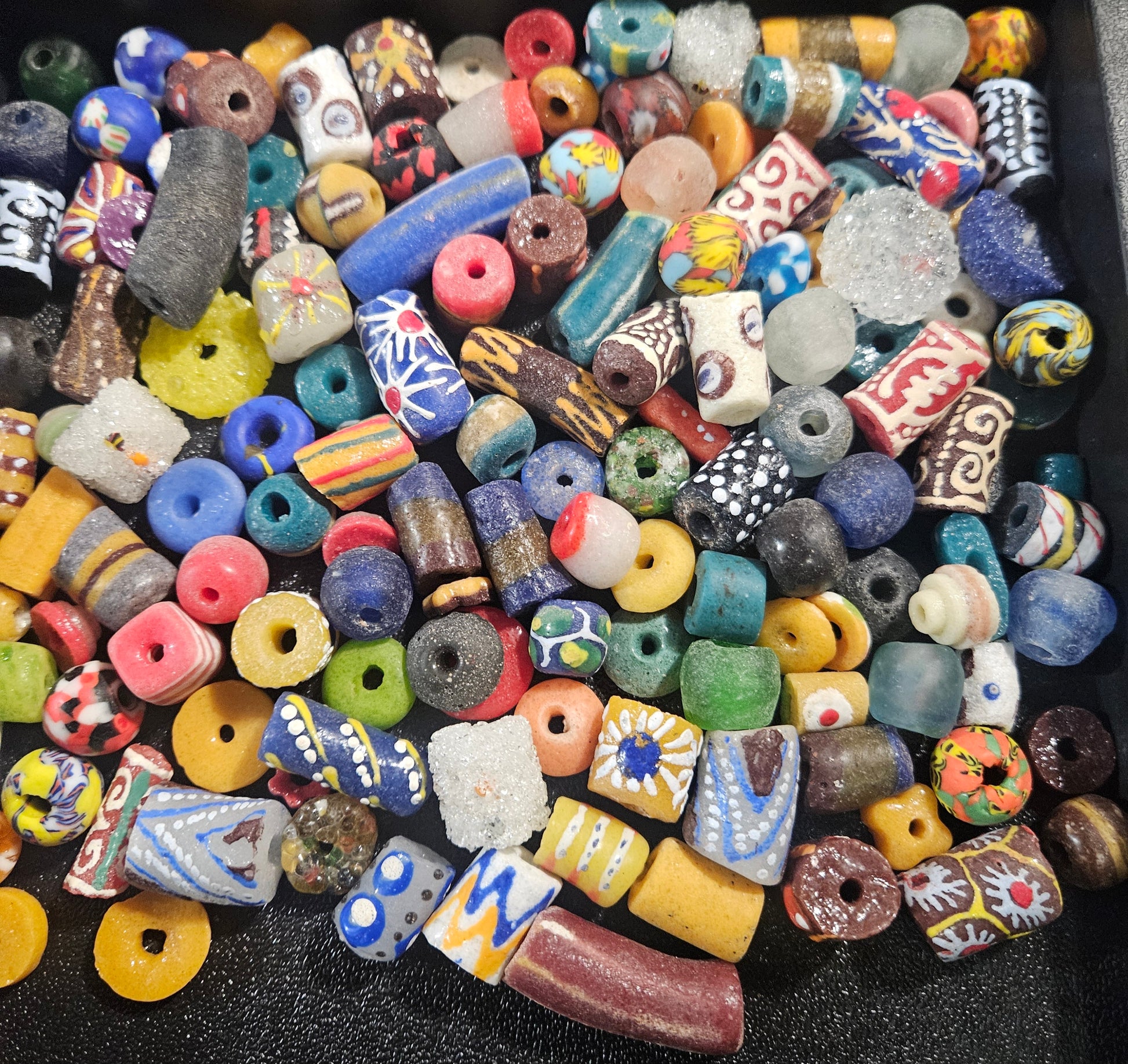 Detail shot highlighting recycled glass textures of Krobo beads in assorted colors.