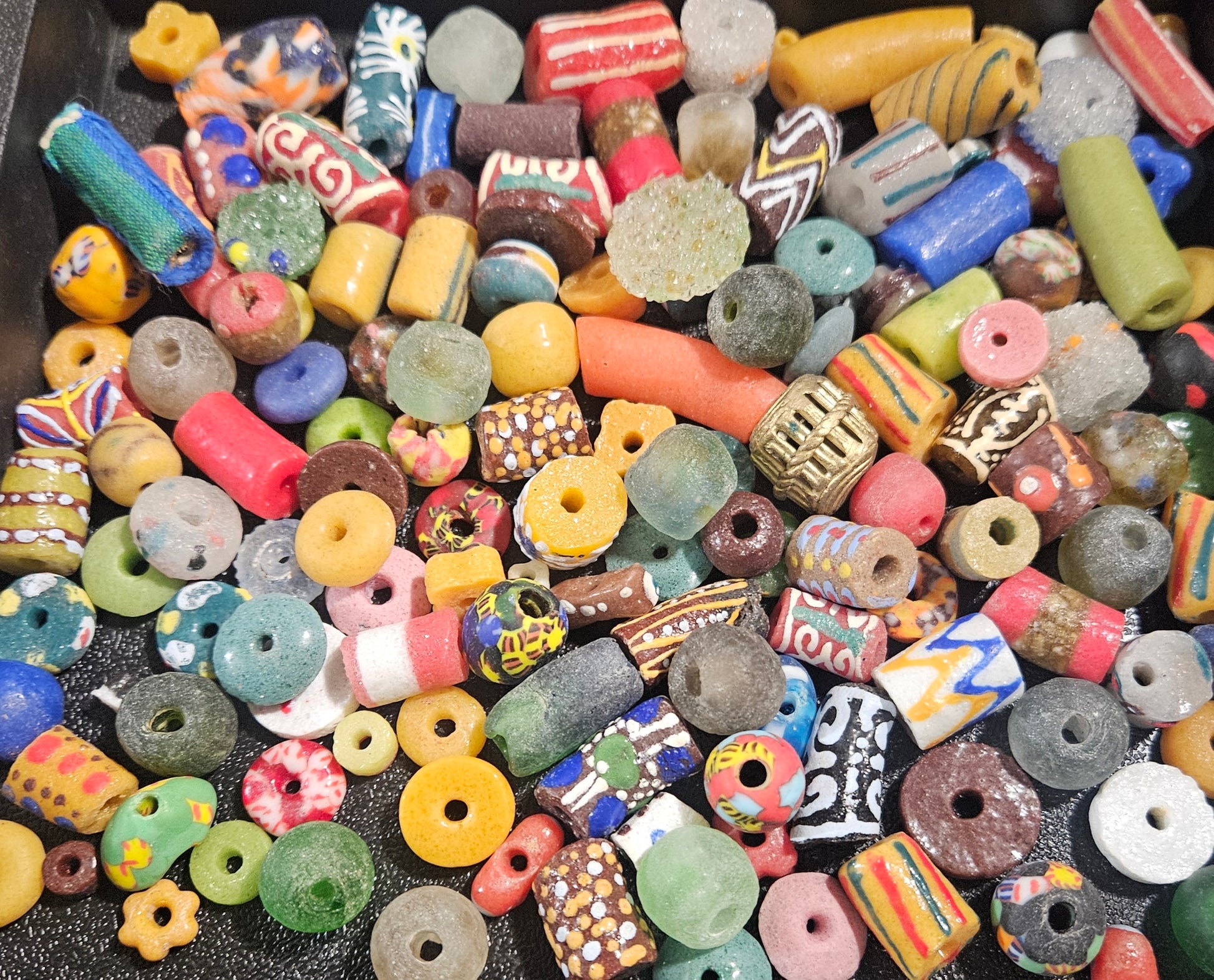 Close-up showing vibrant hand-painted Krobo beads from Ghana.