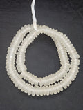 Authentic handmade crystal white Krobo translucent recycled glass rondelle beads from Ghana featuring a matte frosted finish for jewelry making and wholesale sourcing.
