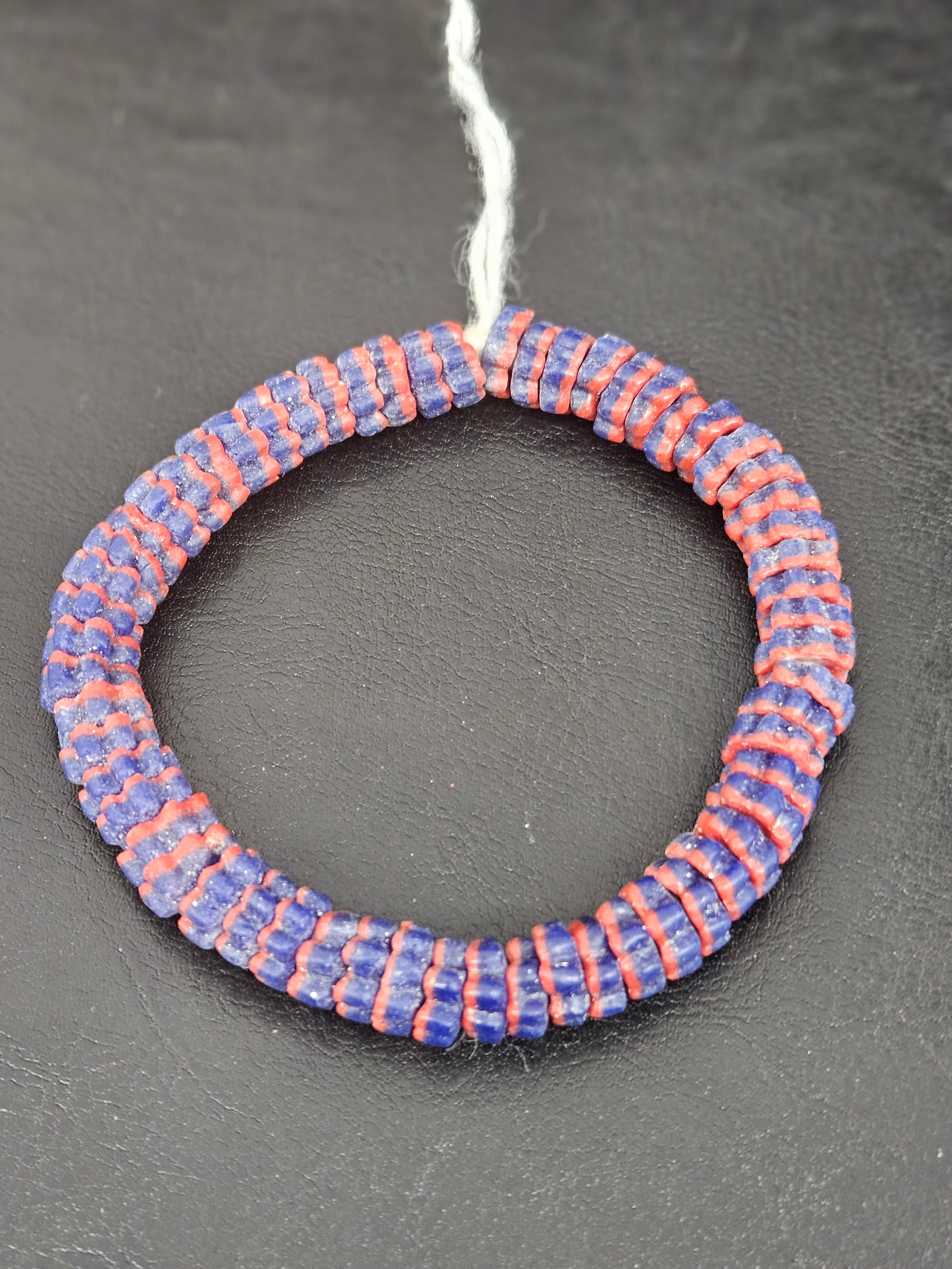 Handcrafted royal blue and coral Krobo glass spacer beads from Ghana featuring recycled glass artisan craftsmanship and striped spacer-bead design.