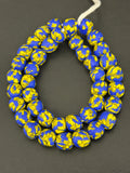Authentic Fused Krobo recycled glass beads handcrafted in Ghana featuring royal blue and golden yellow fused patterns on approximately 44 artisan-made beads strung on a strand