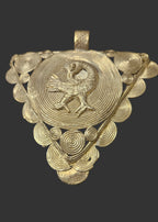 Front view of oversized Sankofa Bird Adinkra brass pendant from Ghana with triangular openwork design, spiral decoration, and large bail.