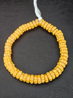 Handcrafted solid golden yellow Krobo glass spacer beads from Ghana featuring recycled glass artisan craftsmanship and rounded spacer-bead design