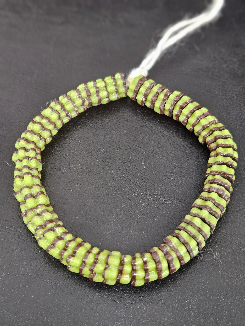 Handcrafted spring green and cocoa brown Krobo glass spacer beads from Ghana featuring recycled glass artisan craftsmanship and striped spacer-bead design.